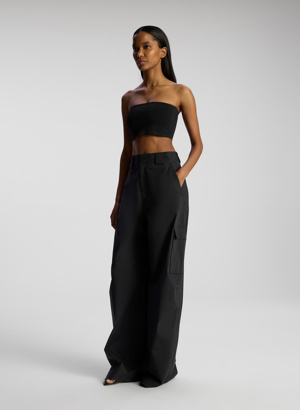 view of woman wearing black strapless crop top and black pants