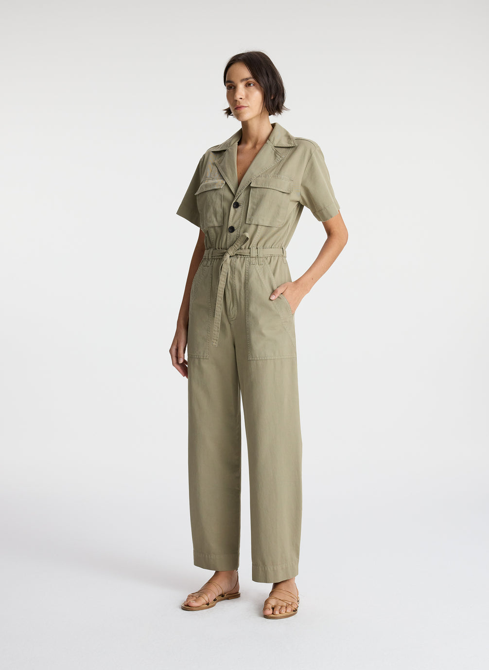 side view of woman in short sleeve khaki jumpsuit