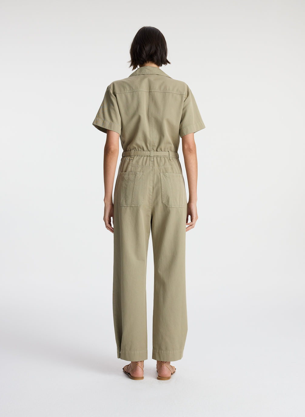 back view of woman in short sleeve khaki jumpsuit