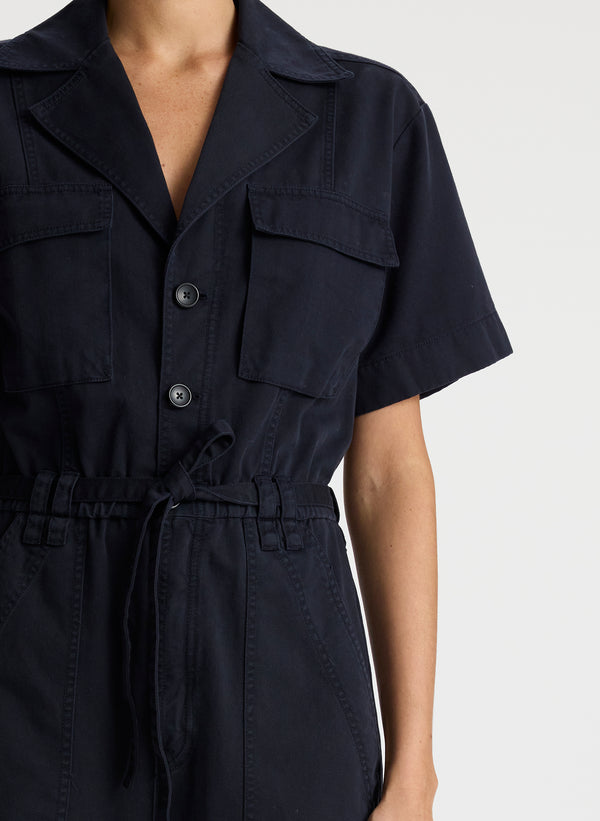 detail view of woman in short sleeve navy blue jumpsuit