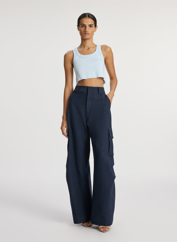 front view of woman wearing light blue cropped rib tank top and navy blue cargo pants