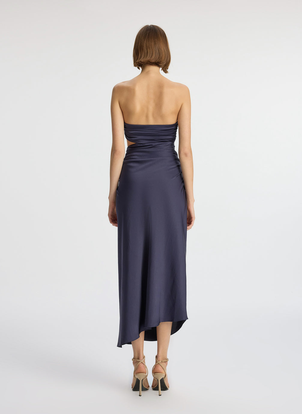 back view of woman wearing navy blue strapless midi dress