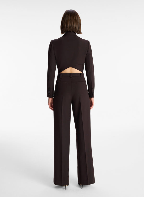 back view of woman wearing black long sleeve jumpsuit with back cutout