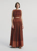 video view of woman wearing brown sleeveless top and matching maxi skirt