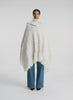 360 degree video view of woman wearing cream cable knit poncho with fringe