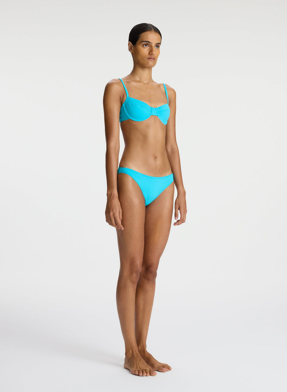 side  view of woman wearing aqua bikini set