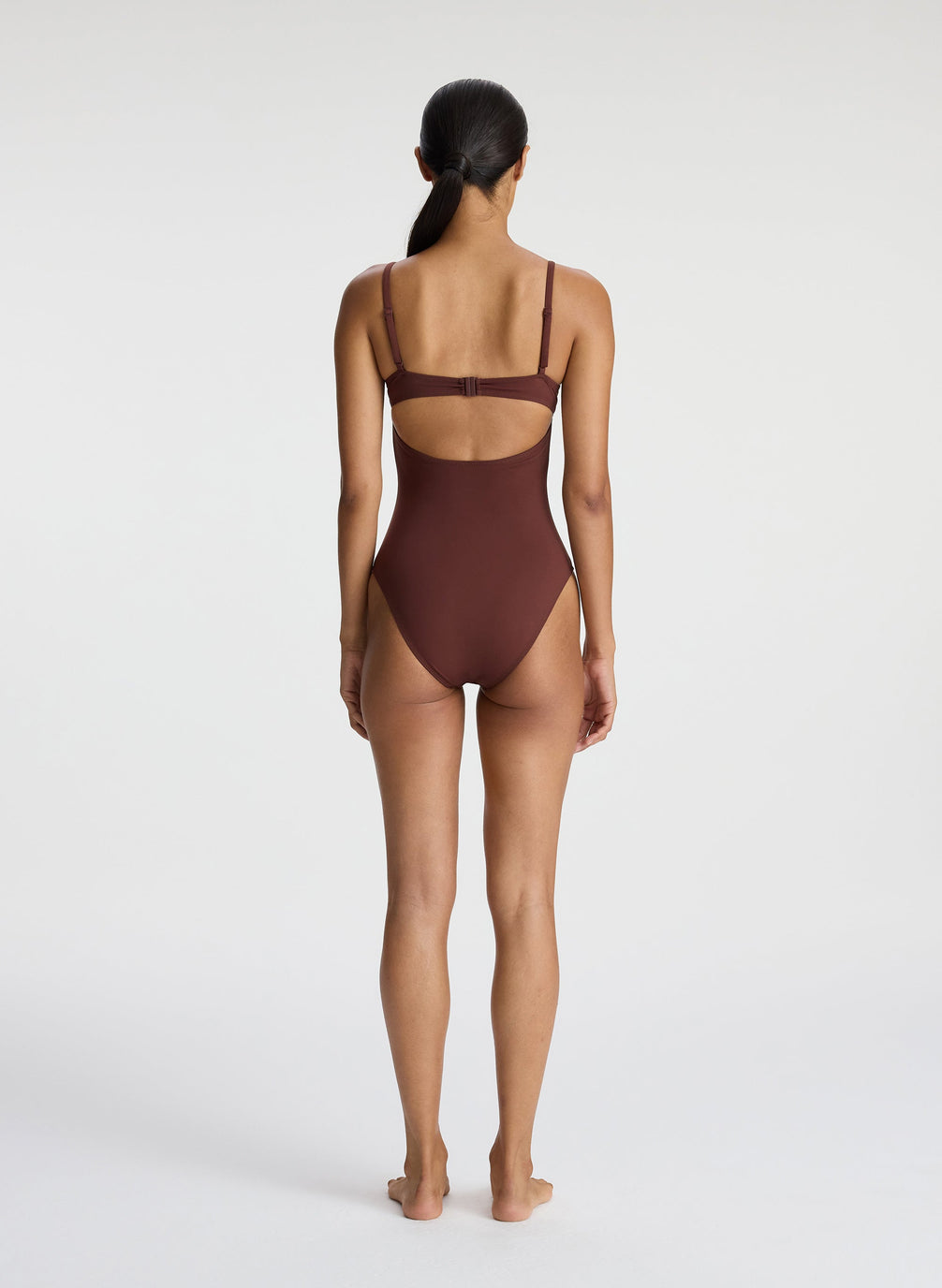 back view of woman wearing brown one piece swimsuit