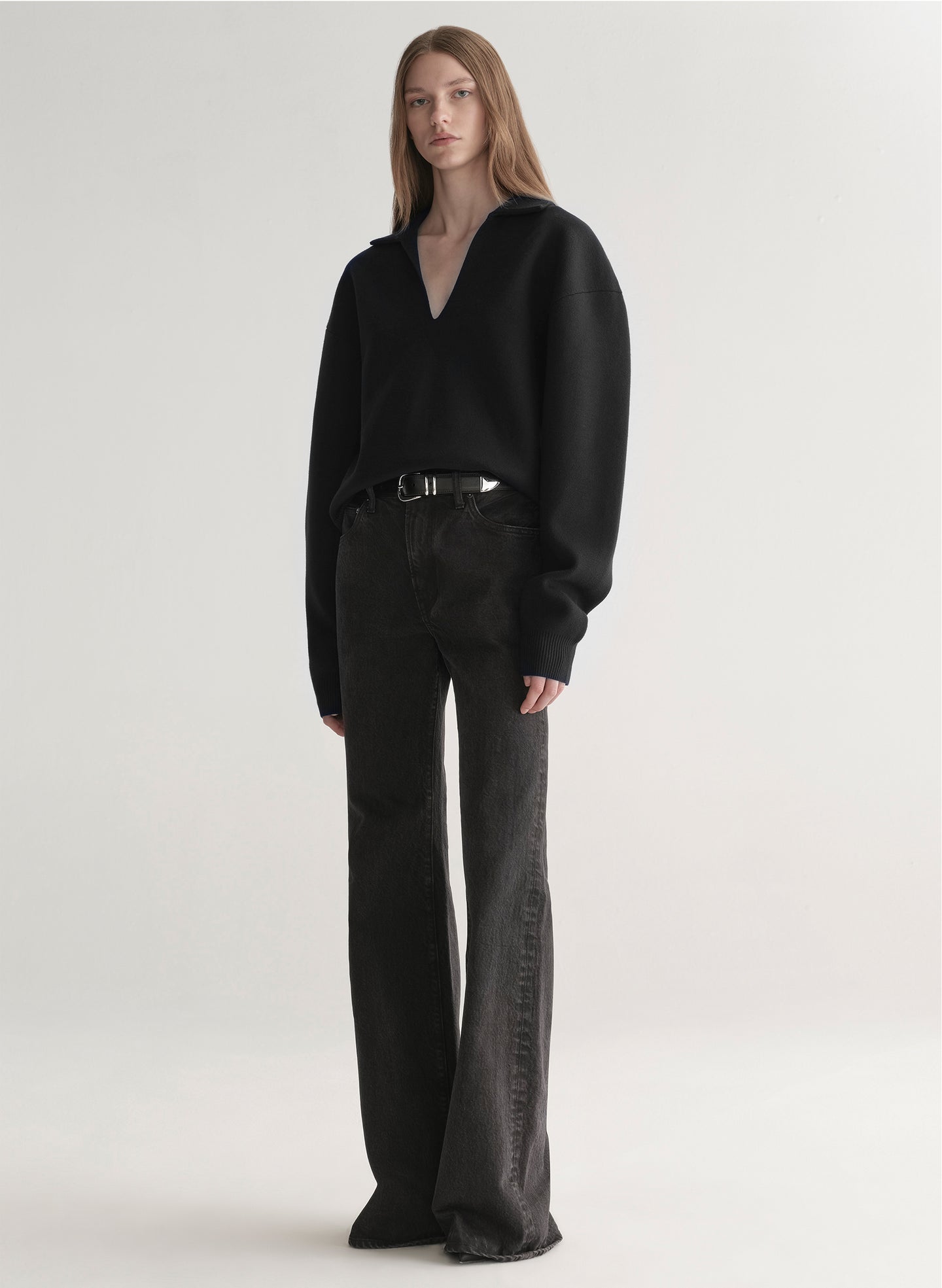 woman wearing black sweater with black denim jeans