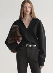 woman wearing black sweater with black denim jeans