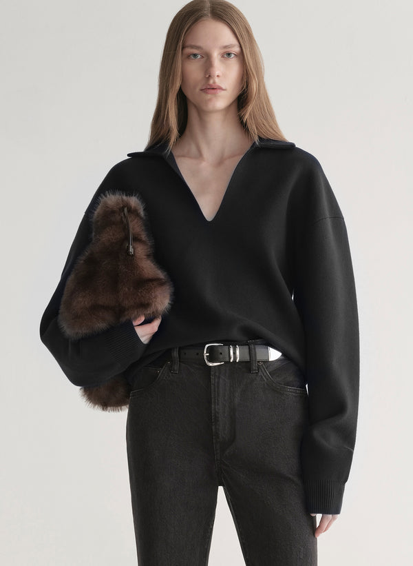 woman wearing black sweater with black denim jeans