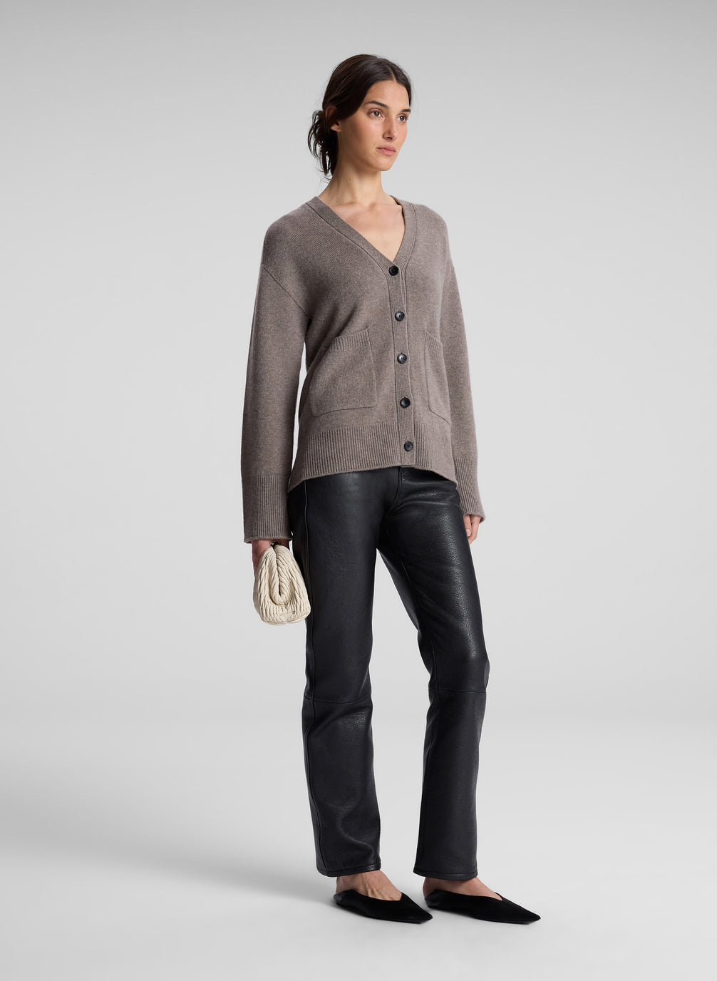 woman wearing grey cardigan and black leather pants