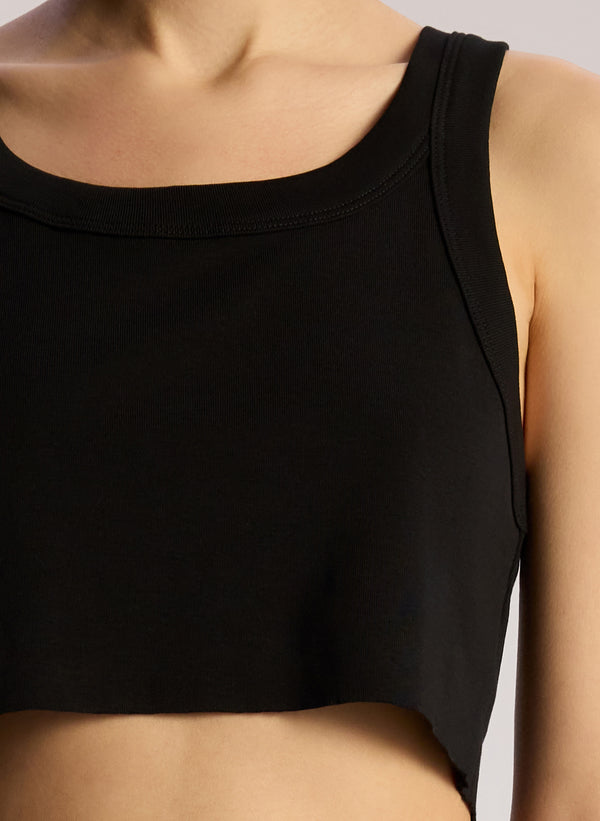 detail view of woman wearing black cropped rib tank top with black maxi skirt