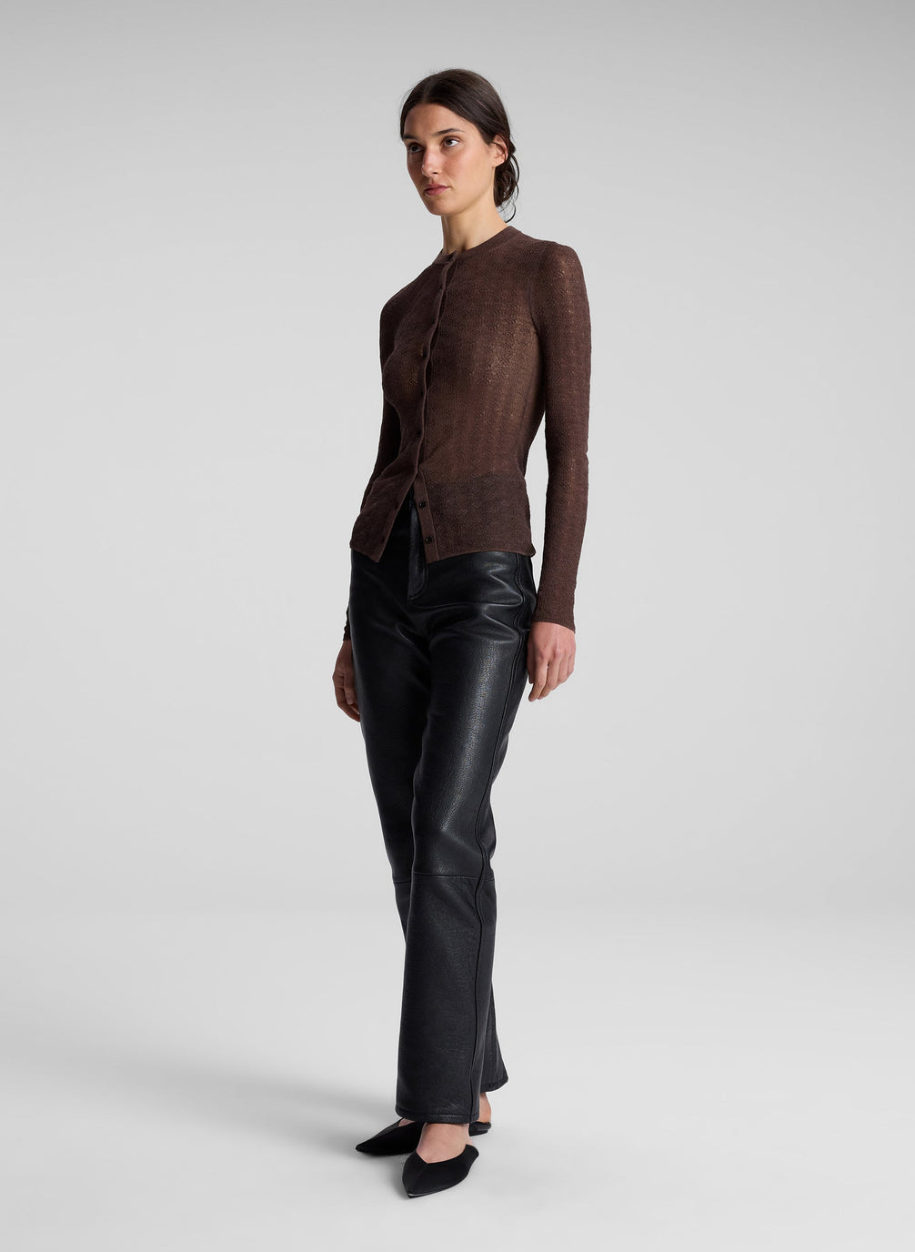 woman wearing brown cardigan and black leather pants