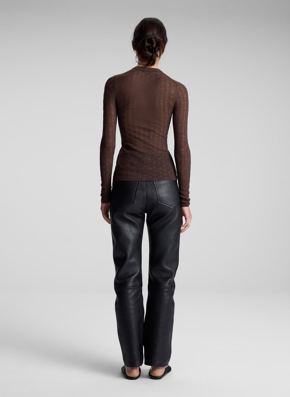 woman wearing brown cardigan and black leather pants