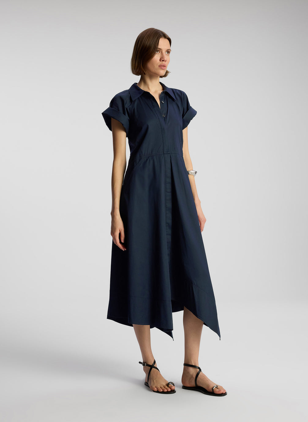 side view of woman wearing navy blue midi shirtdress