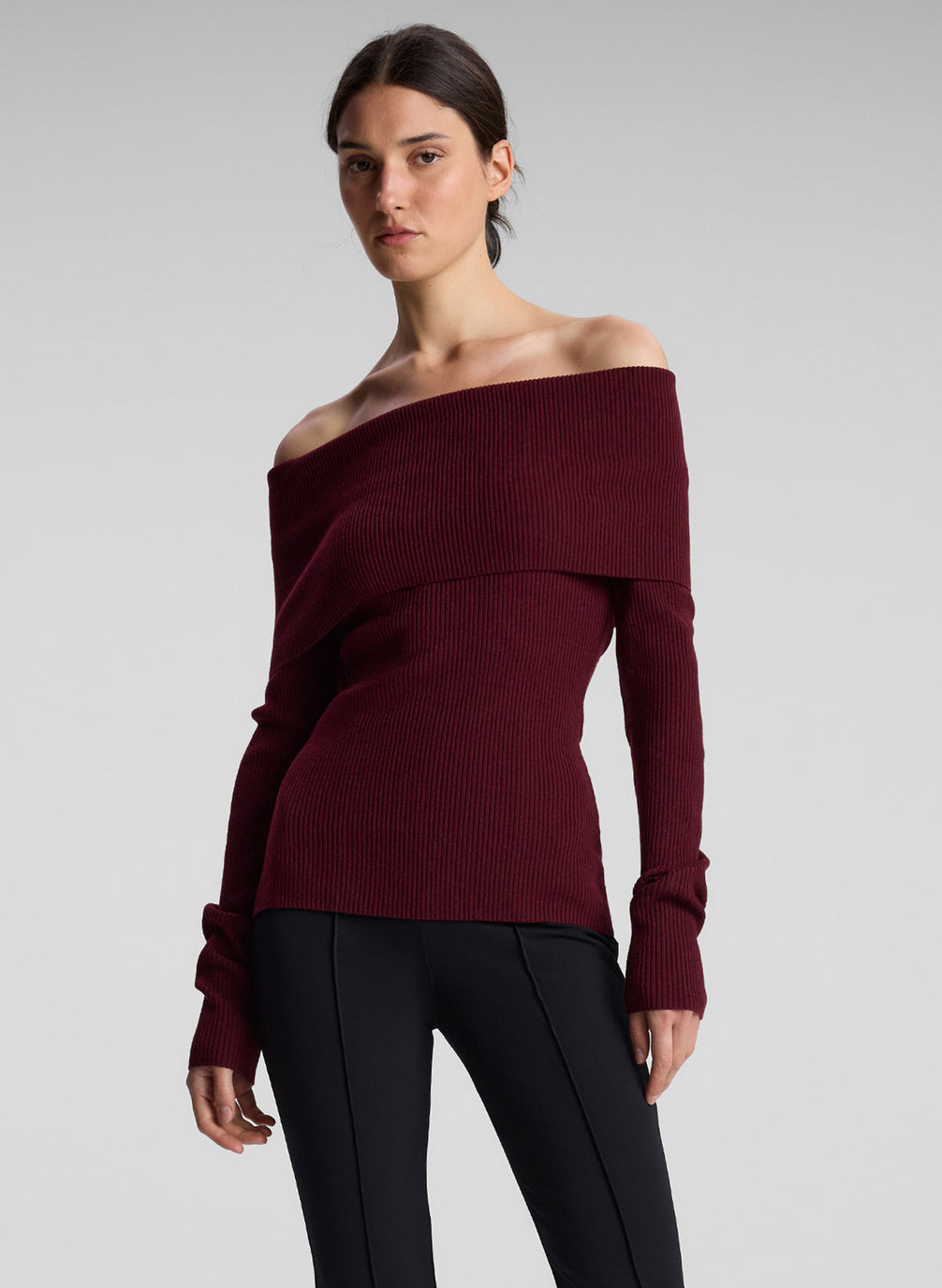 woman wearing off shoulder burgundy top and black pants