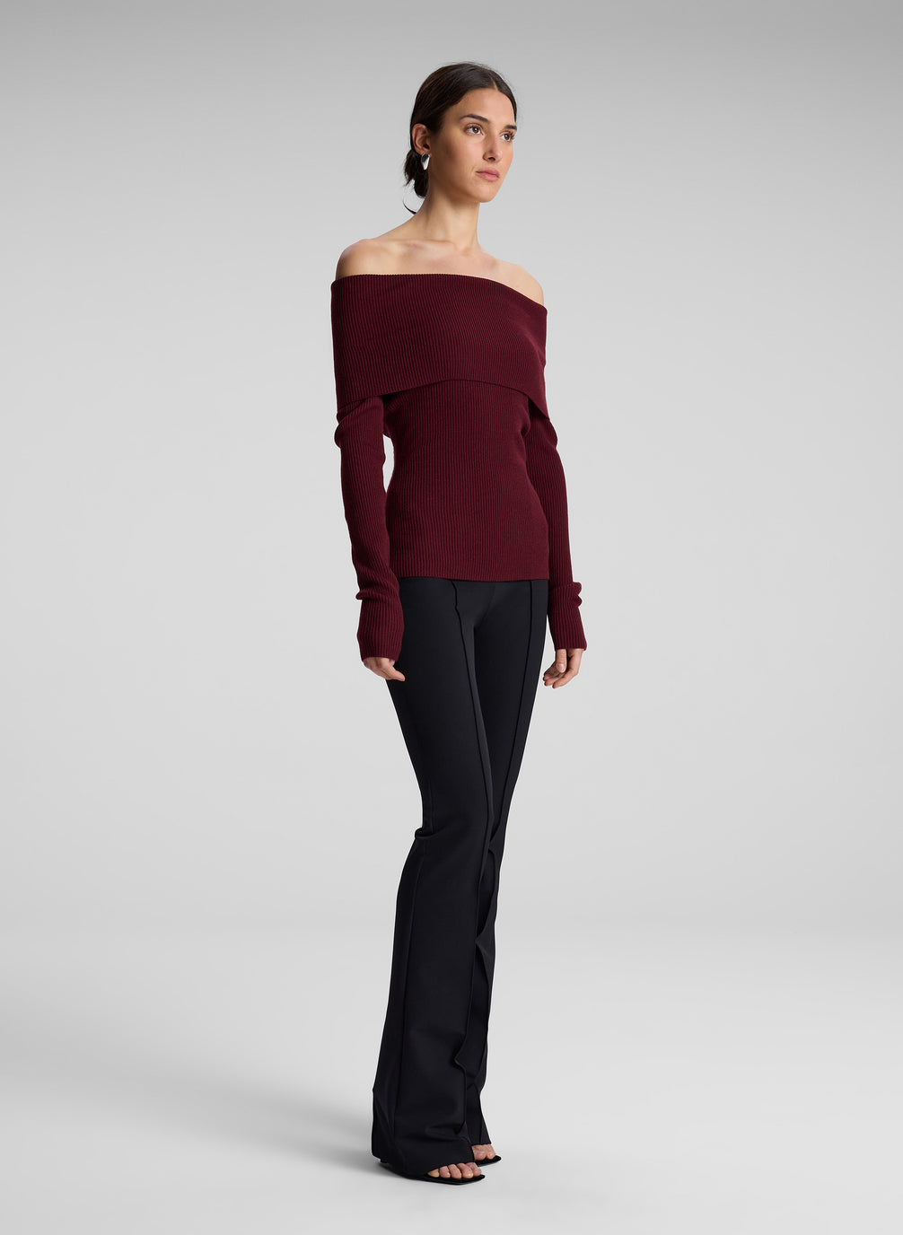 woman wearing off shoulder burgundy top and black pants