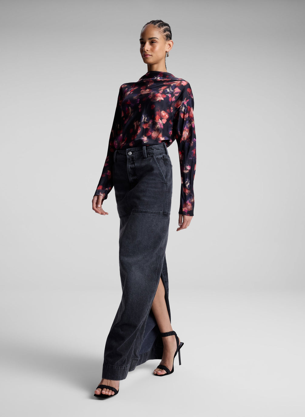 woman wearing printed top and black denim maxi skirt