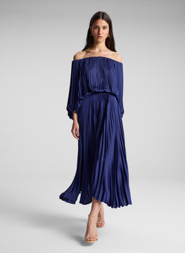 woman wearing navy blue off shoulder pleated dress