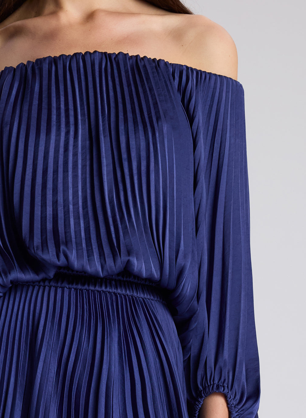 woman wearing navy blue off shoulder pleated dress