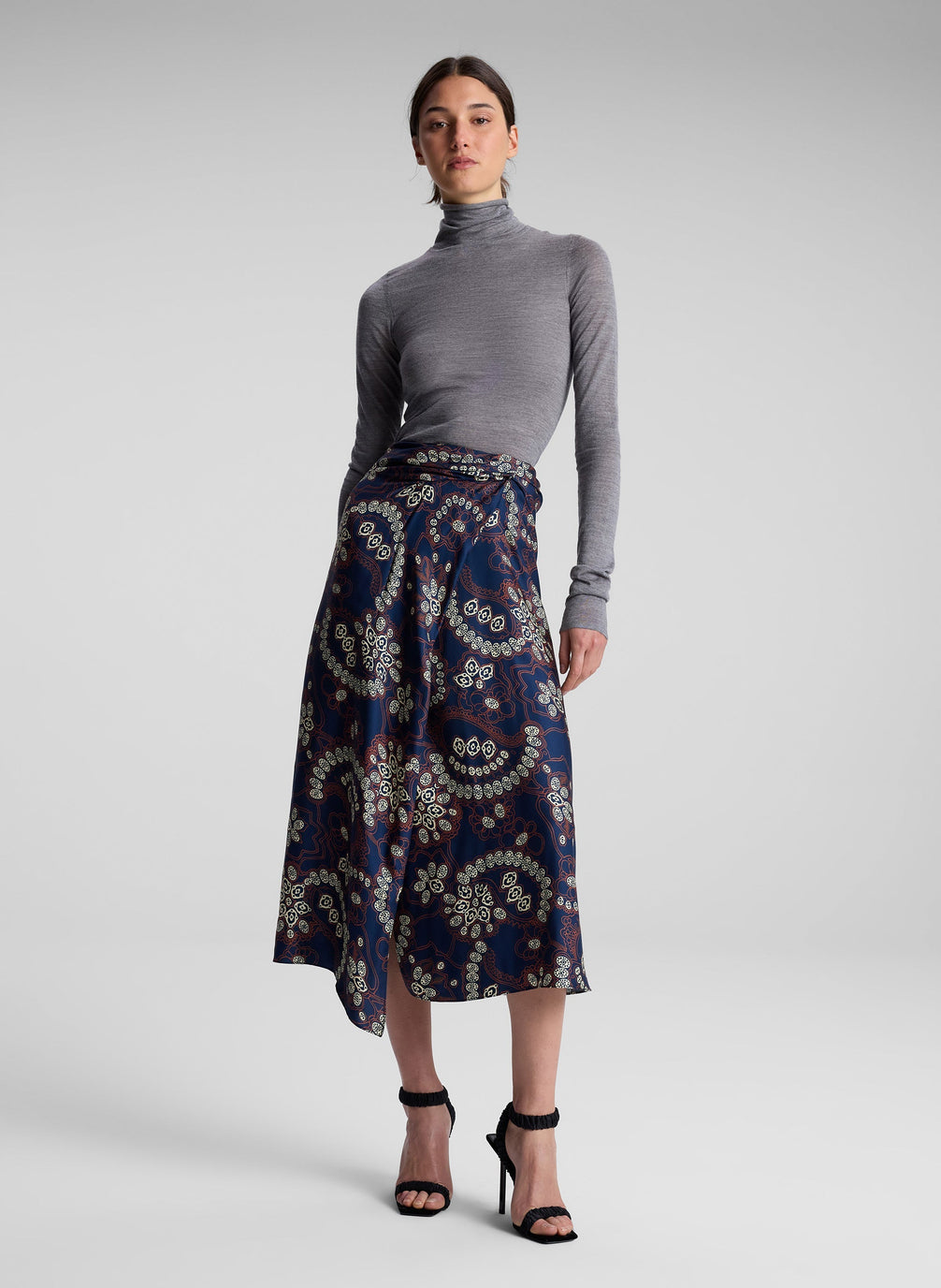 woman wearing grey turtleneck and floral midi skirt