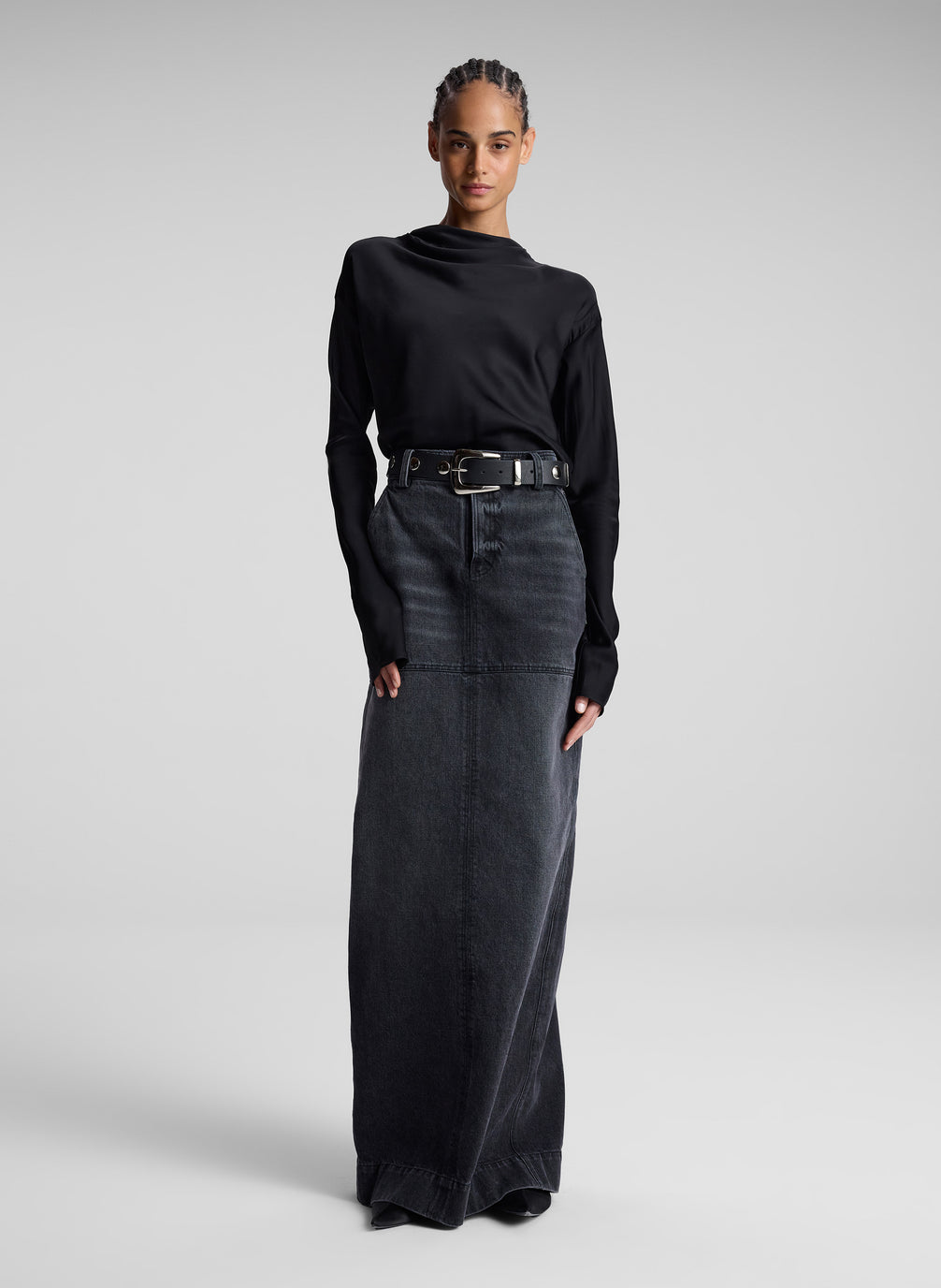 woman wearing black top and black denim maxi skirt