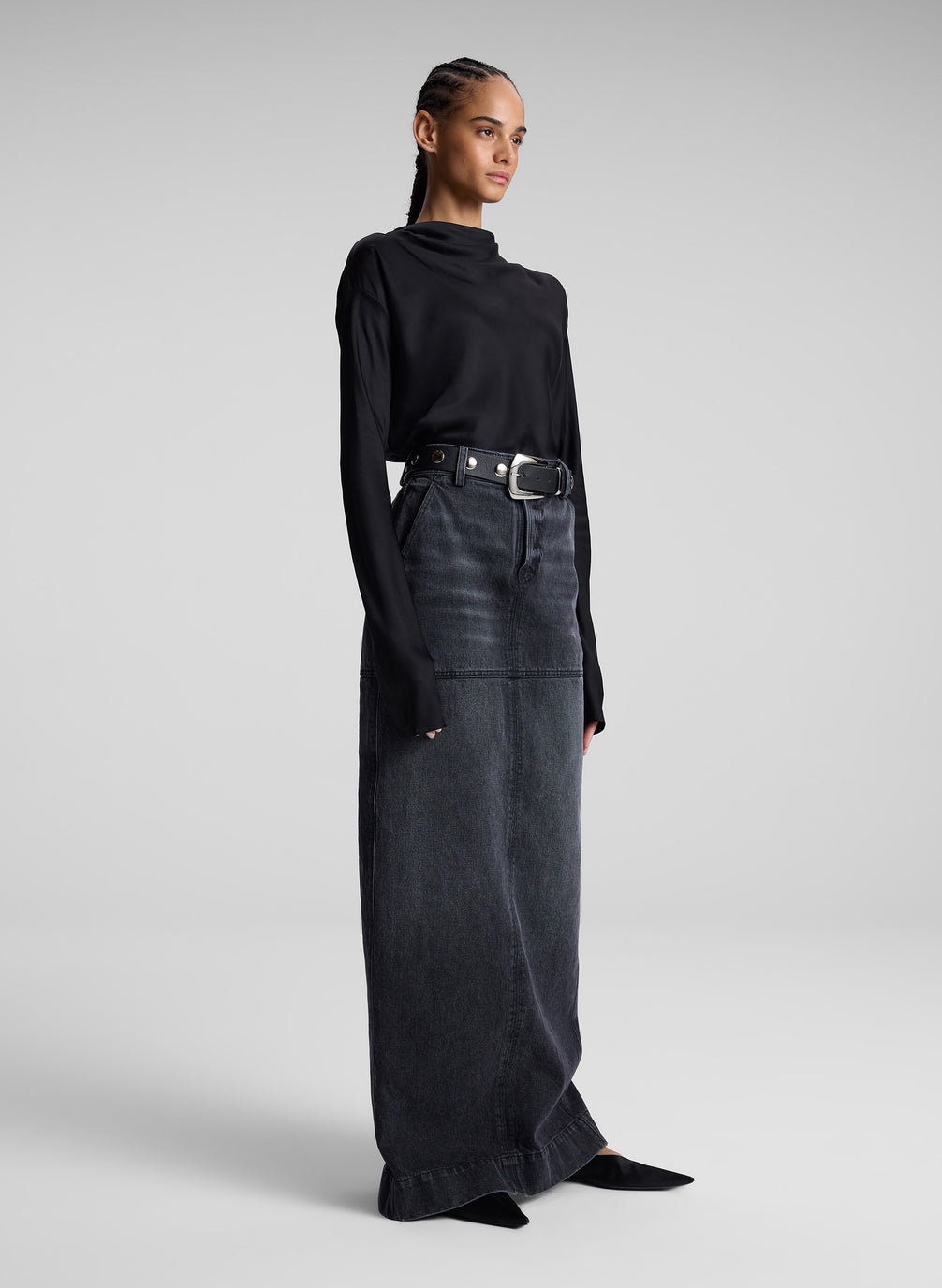 woman wearing black top and black denim maxi skirt