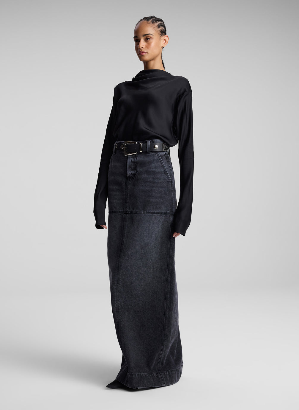 woman wearing black top and black denim maxi skirt