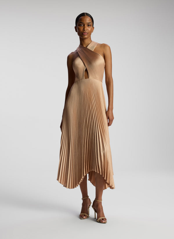 front view of woman wearing blush colored pleated midi dress