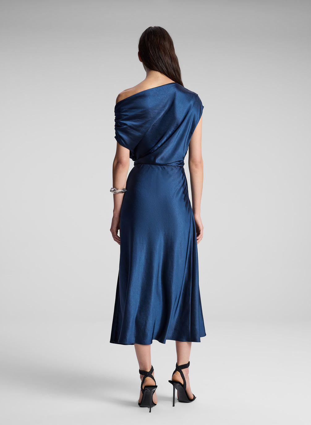 woman wearing navy blue satin midi dress