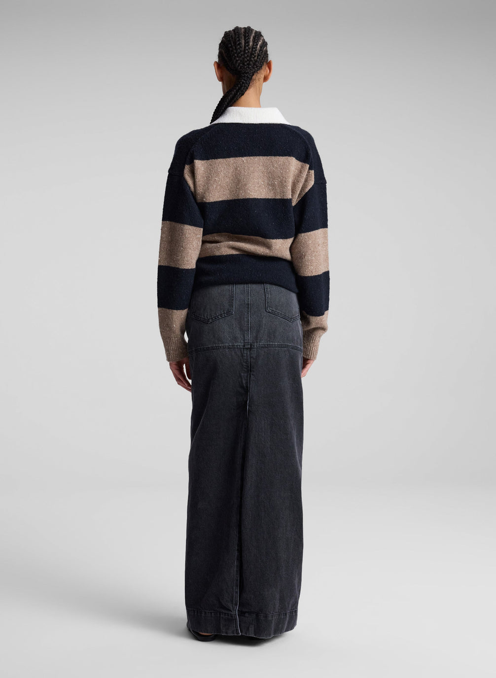 woman wearing striped collared sweater and black denim maxi skirt