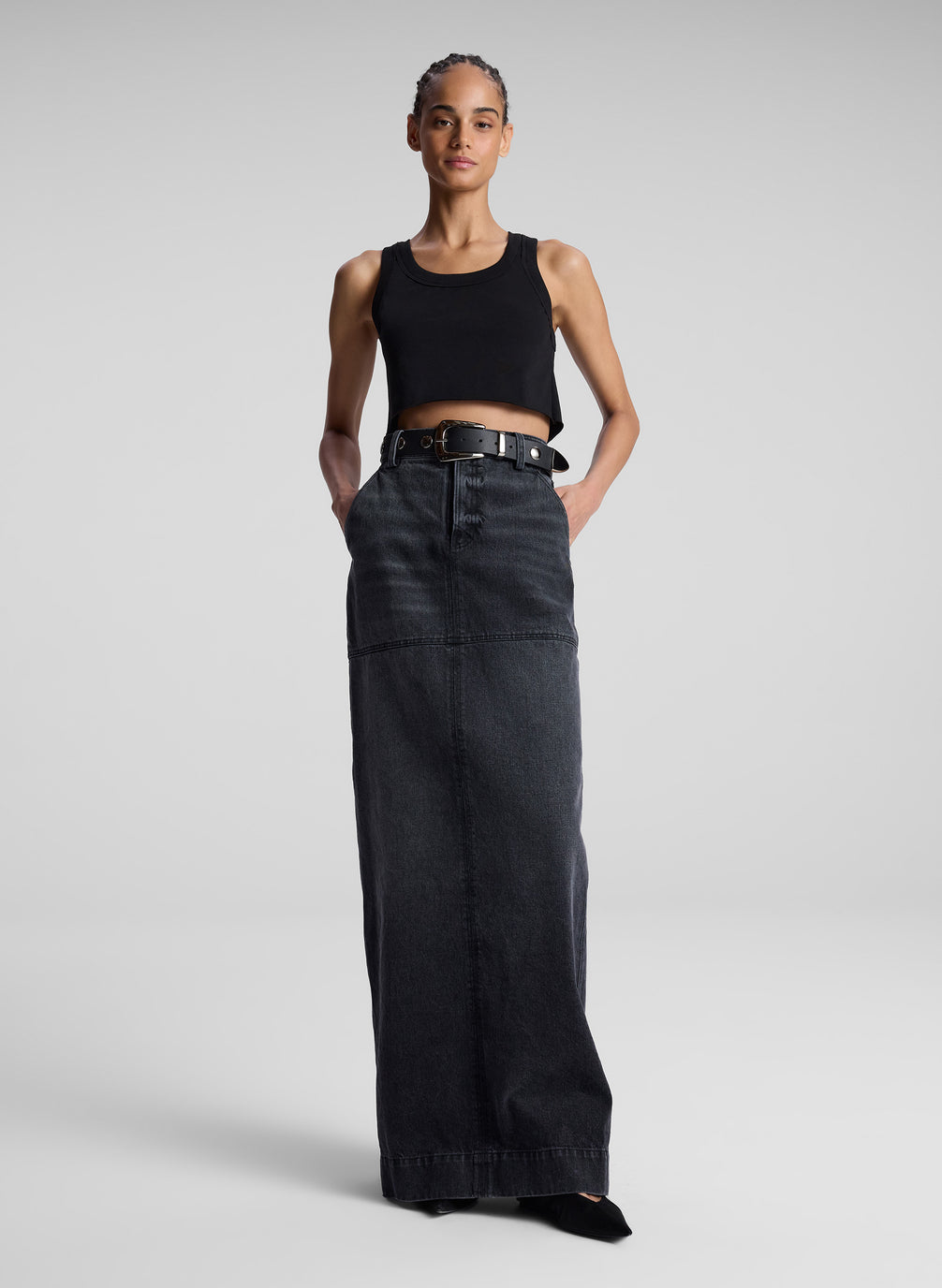 woman wearing black cropped tank top and black denim maxi skirt