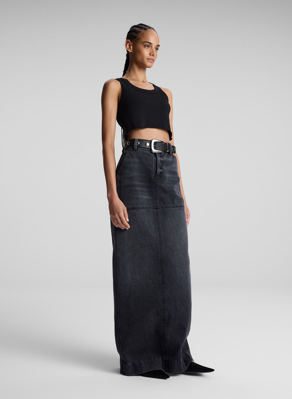 woman wearing black cropped tank top and black denim maxi skirt