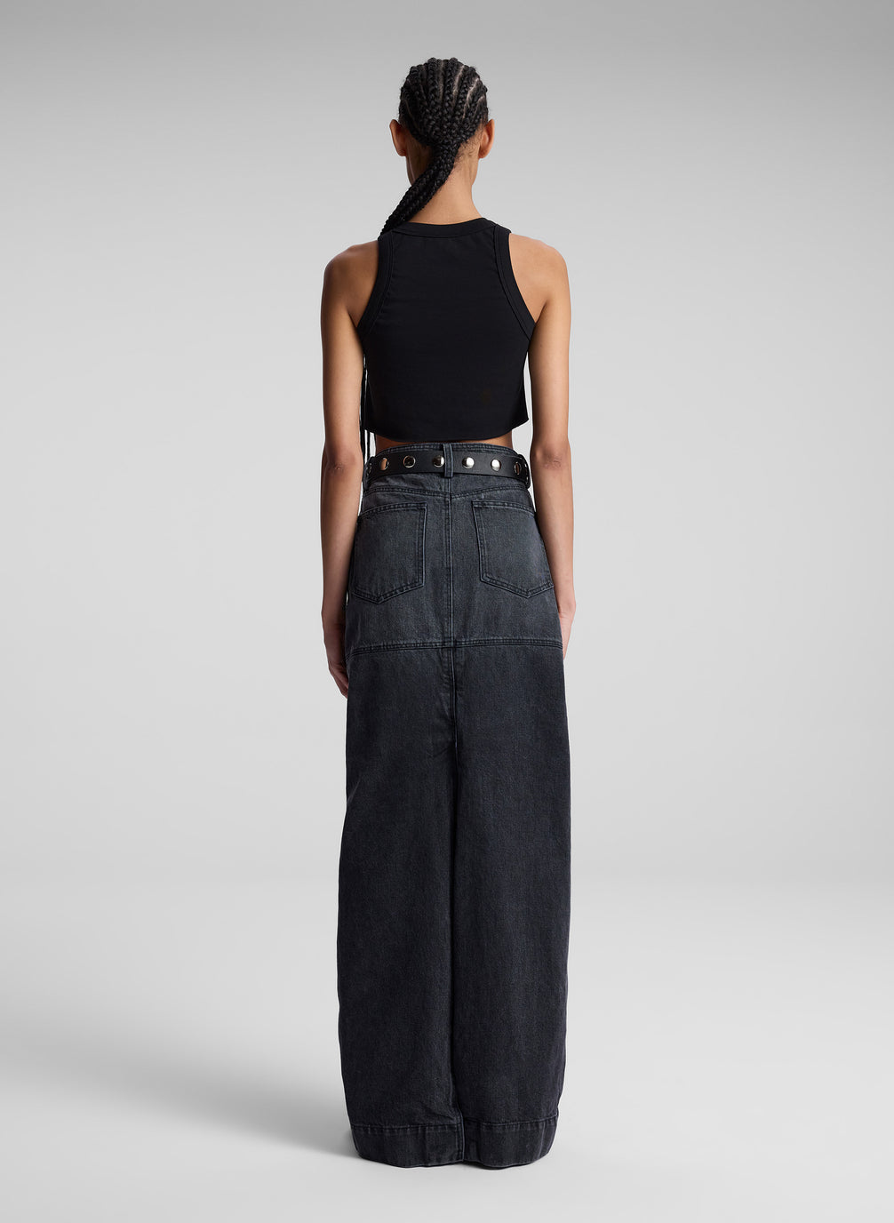 woman wearing black cropped tank top and black denim maxi skirt