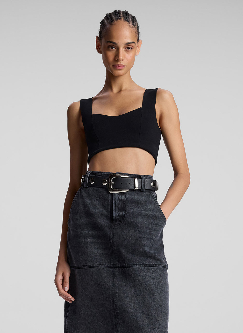 woman wearing black compact knit bra and black denim maxi skirt