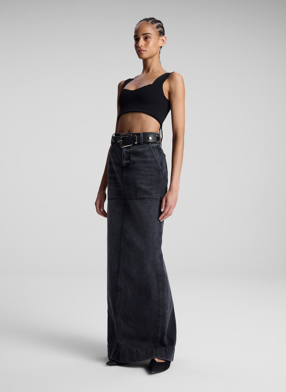 woman wearing black compact knit bra and black denim maxi skirt