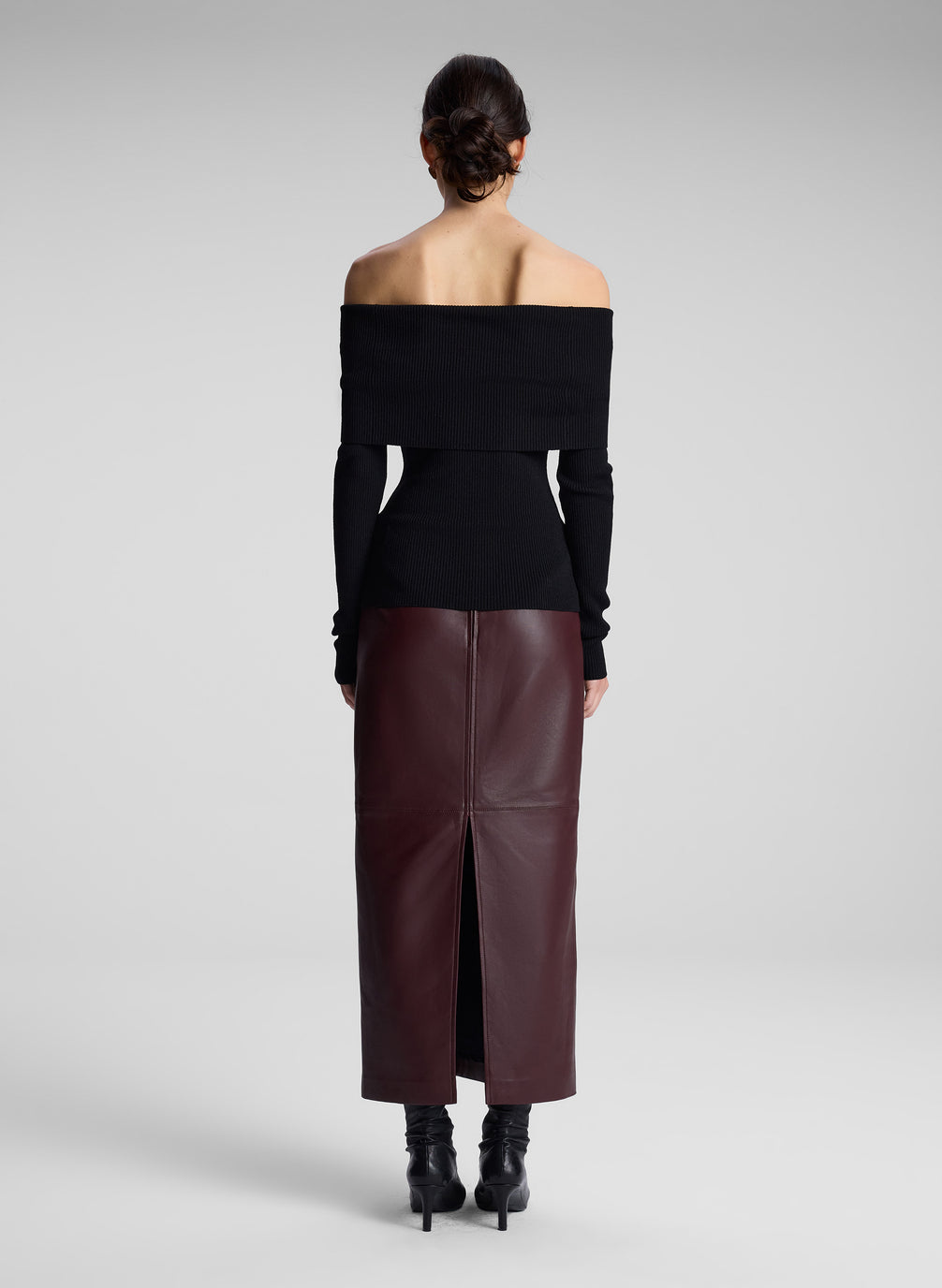 woman wearing black off shoulder top and maroon leather skirt