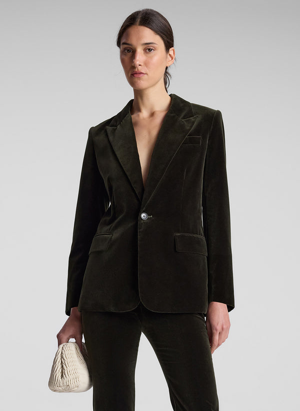 woman wearing olive green velvet suit