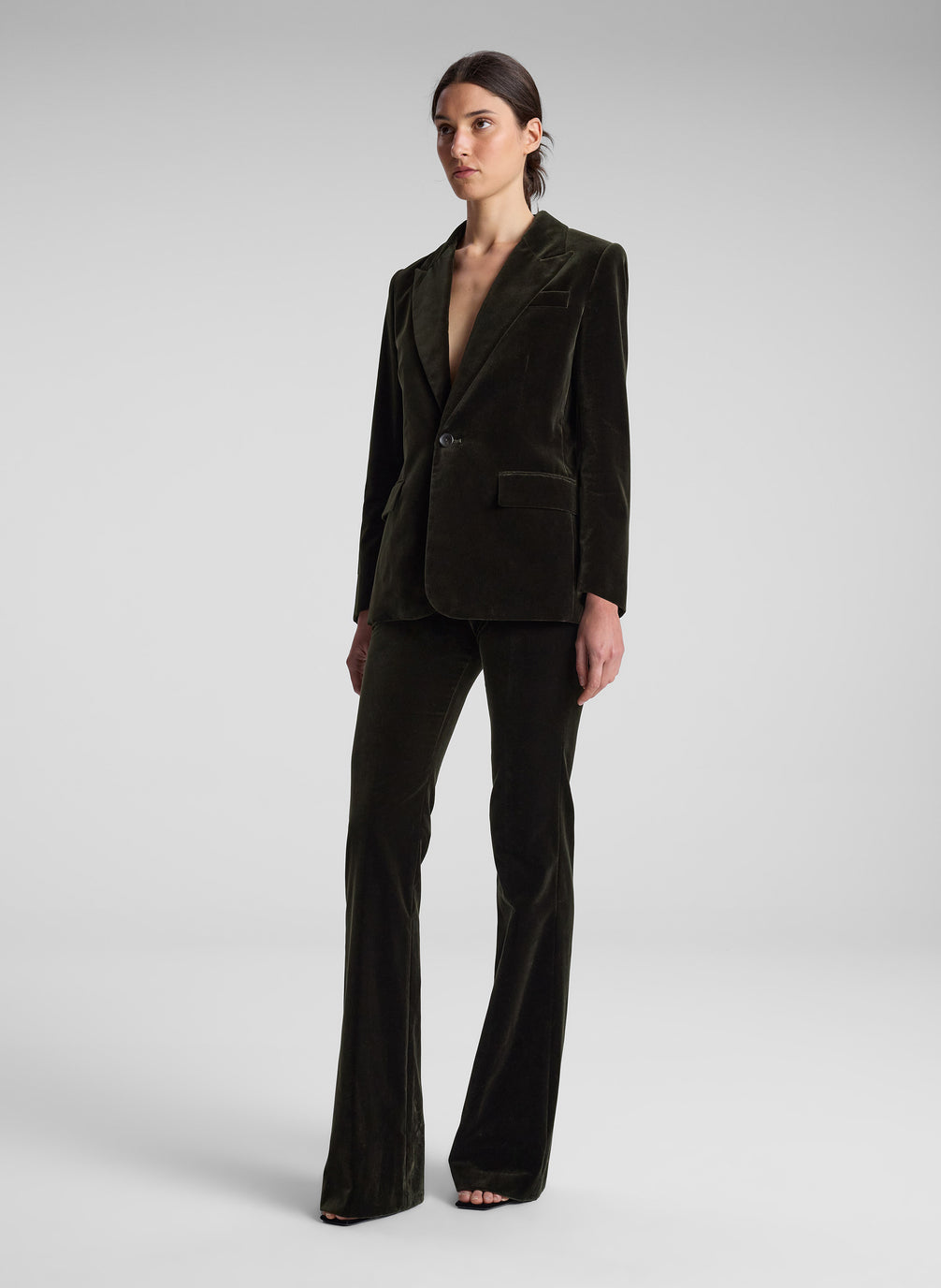 woman wearing olive green velvet suit