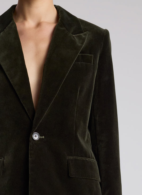 woman wearing olive green velvet suit