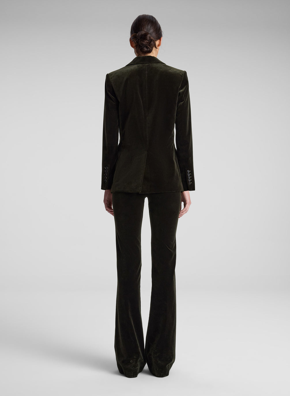 woman wearing olive green velvet suit