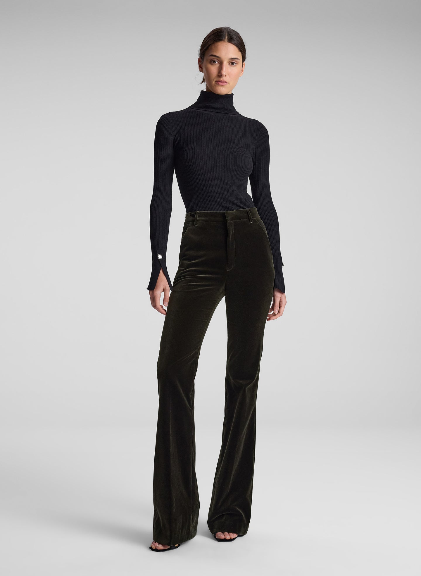 woman wearing black turtleneck and olive green velvet pants