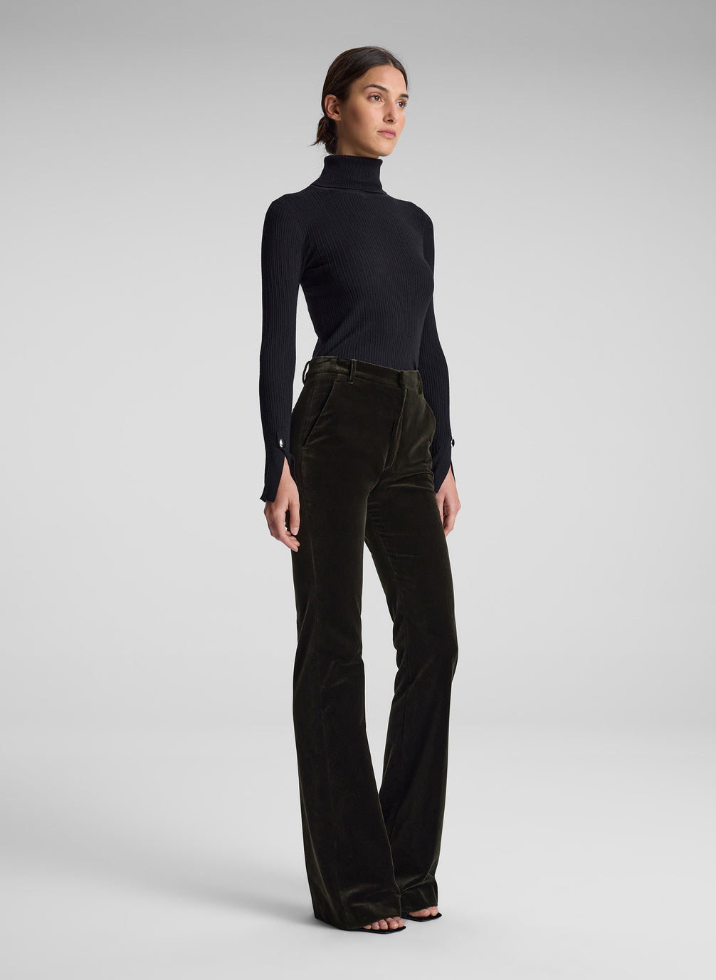 woman wearing black turtleneck and olive green velvet pants