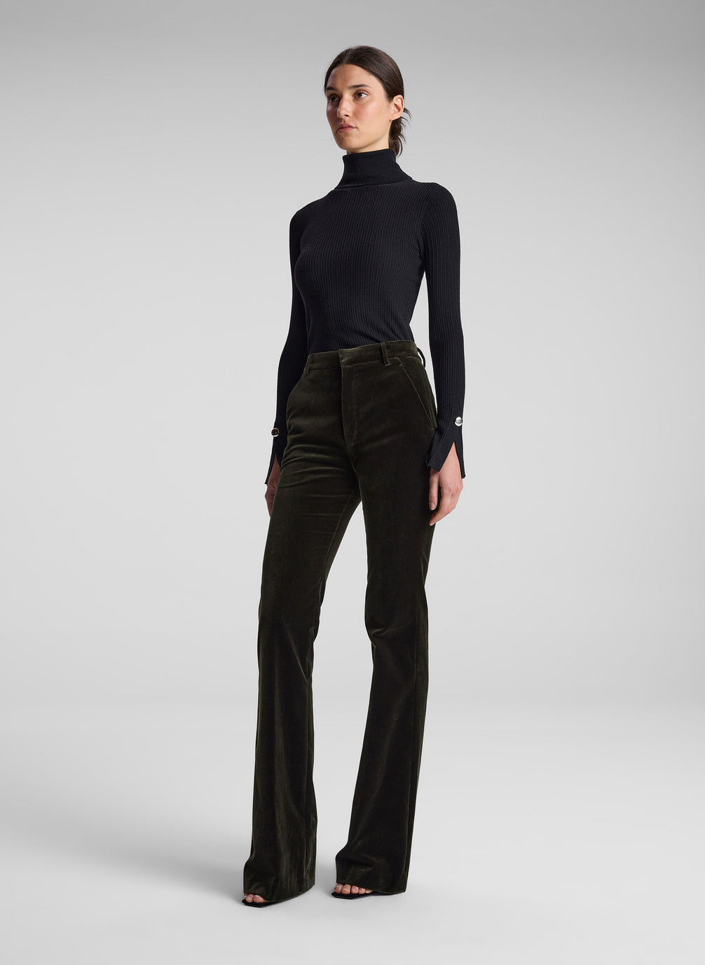 woman wearing black turtleneck and olive green velvet pants