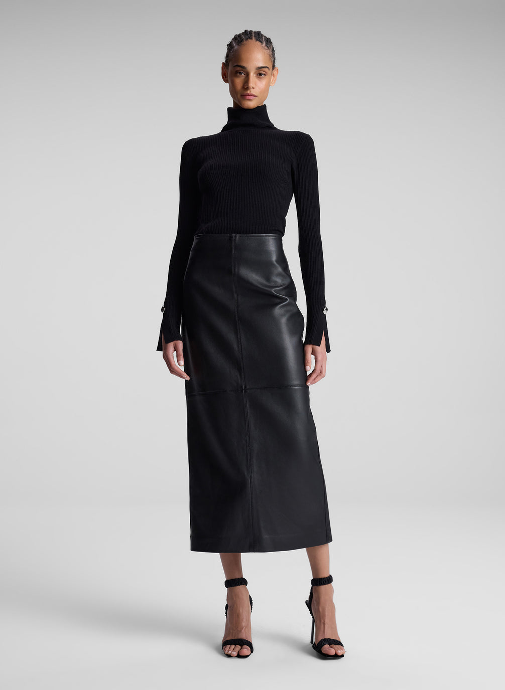 woman wearing black turtleneck and black leather maxi skirt