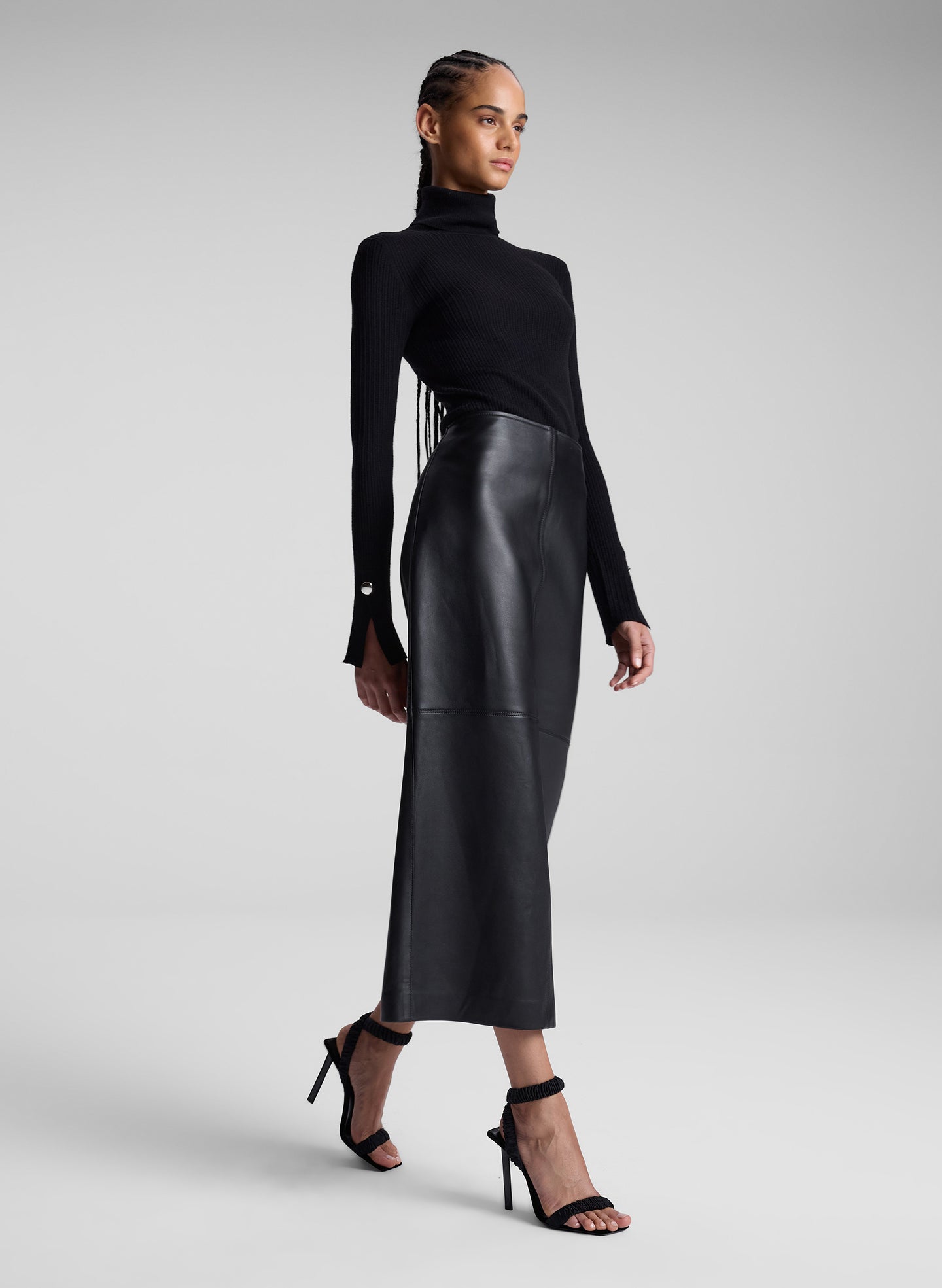 woman wearing black turtleneck and black leather maxi skirt