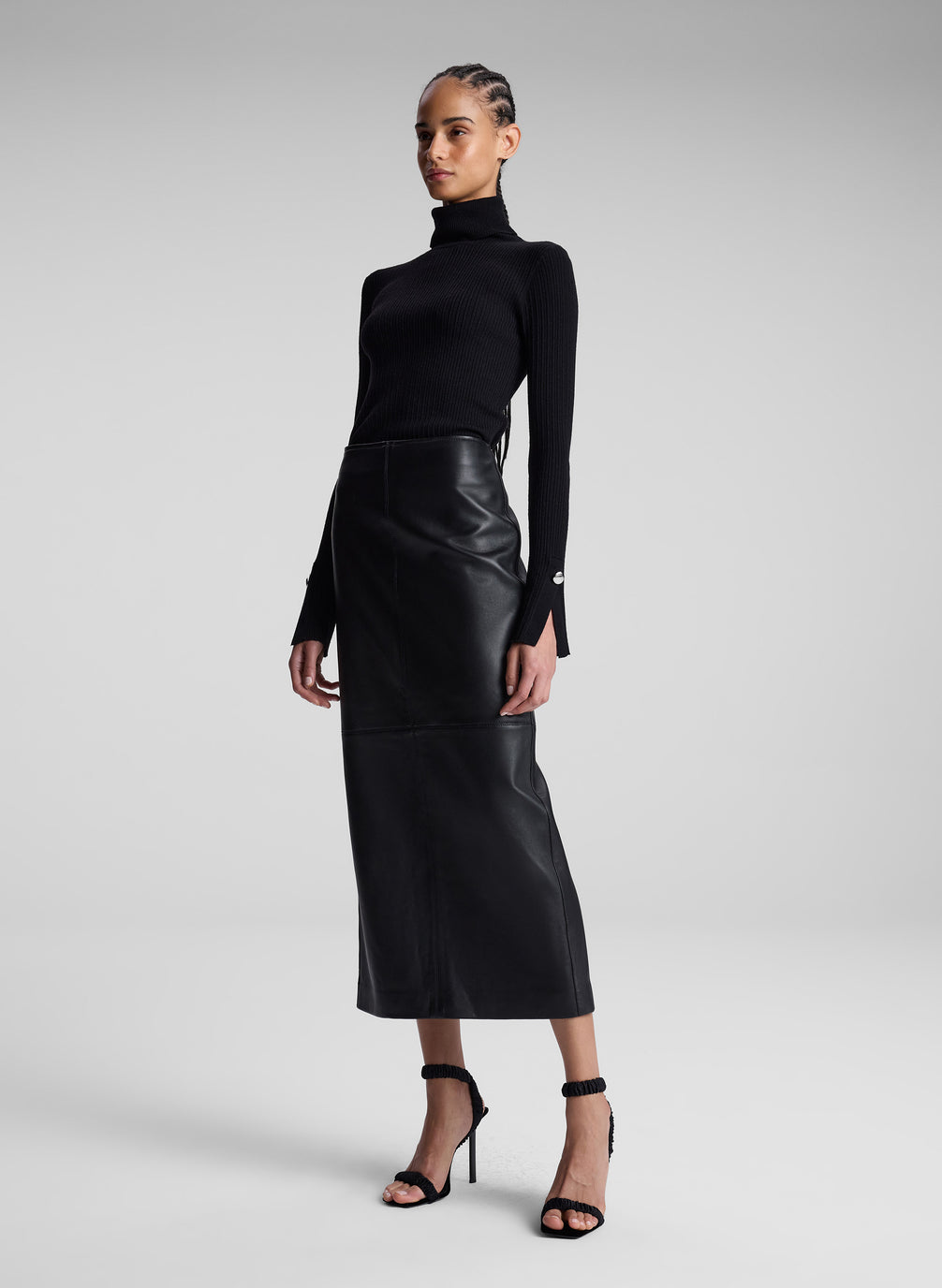 woman wearing black turtleneck and black leather maxi skirt