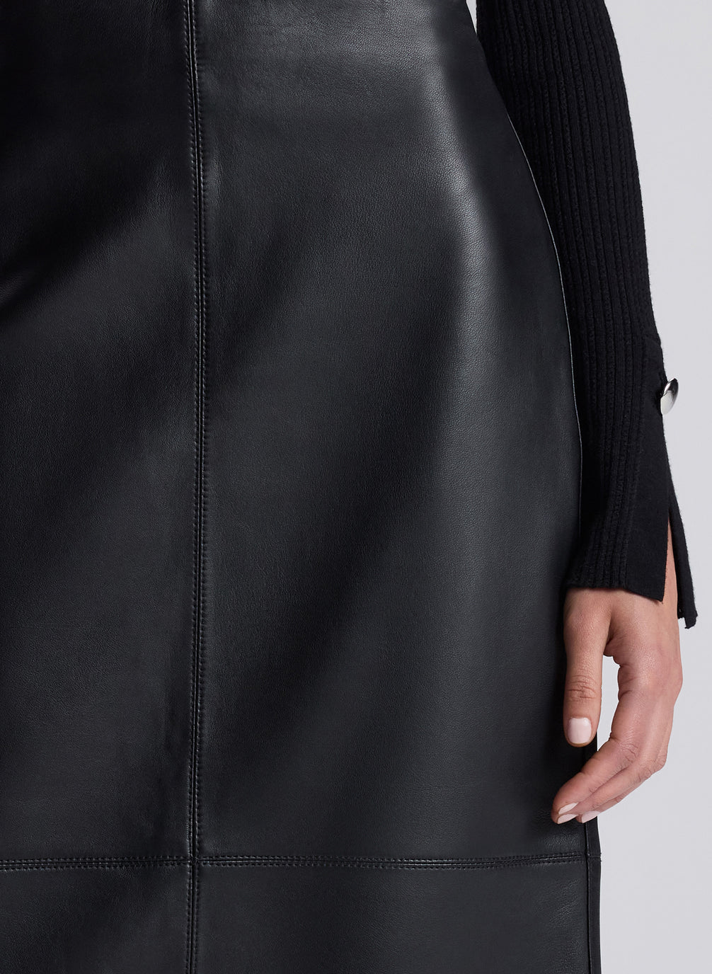 woman wearing black turtleneck and black leather maxi skirt