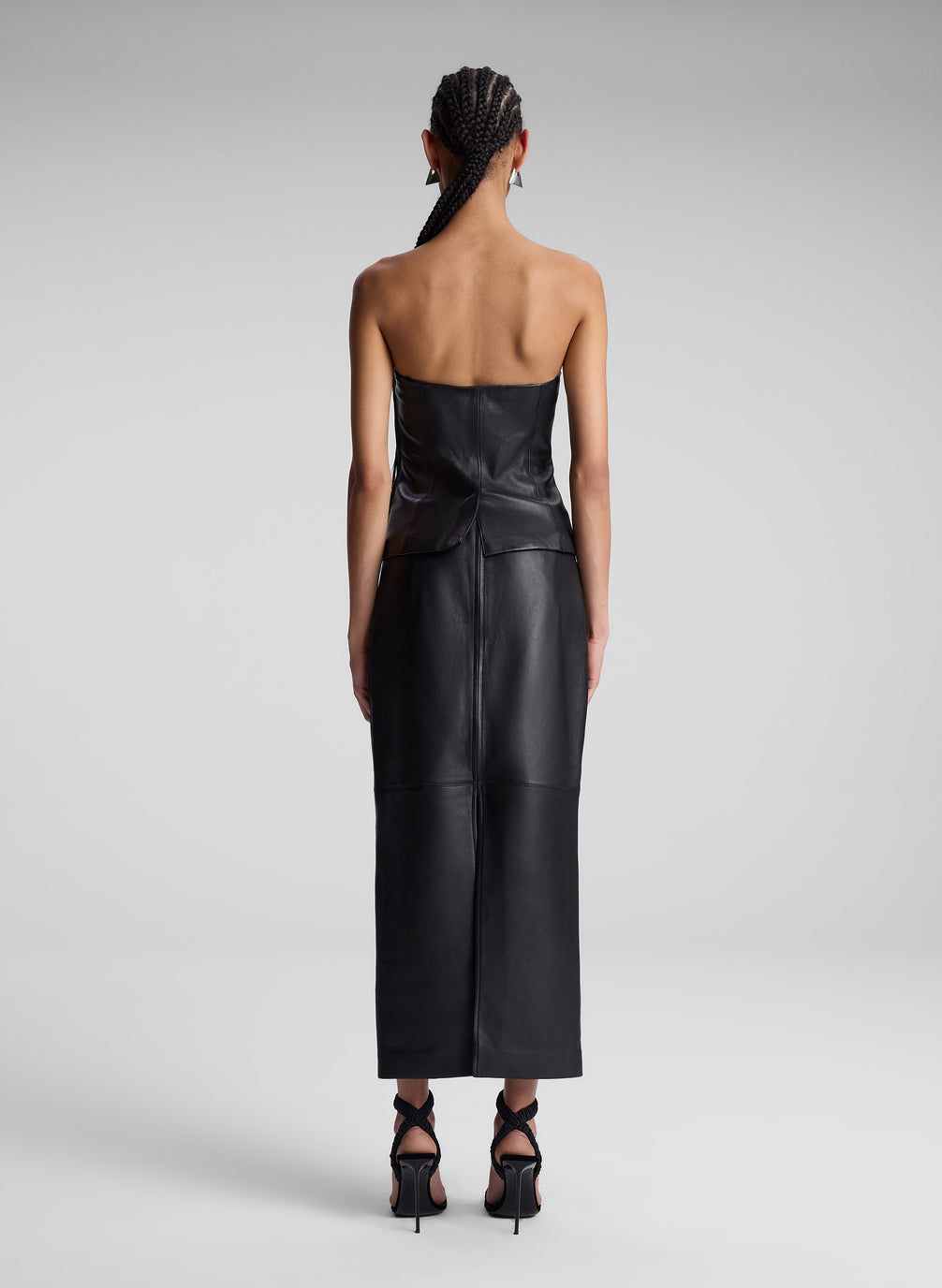 woman wearing black leather top and matching maxi skirt