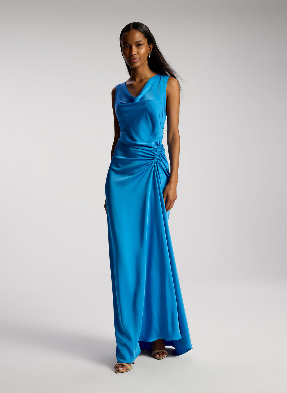 side view of woman wearing blue satin maxi dress